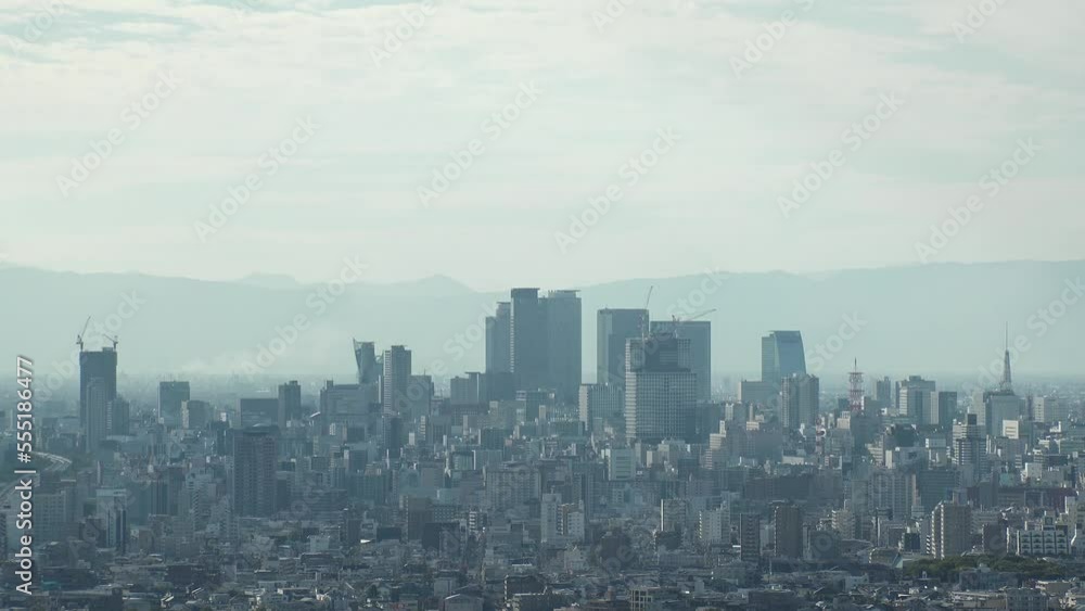 NAGOYA, JAPAN - OCTOBER 2022 : Aerial high angle view of NAGOYA CITY in sunny daytime. View of buildings and street traffic around Nagoya station and Sakae area (central downtown). Time lapse shot. NAGOYA, JAPAN - OCTOBER 2022 : Aerial high angle view of NAGOYA CITY in sunny daytime. View of buildings and street traffic around Nagoya station and Sakae area (central downtown). Time lapse shot.