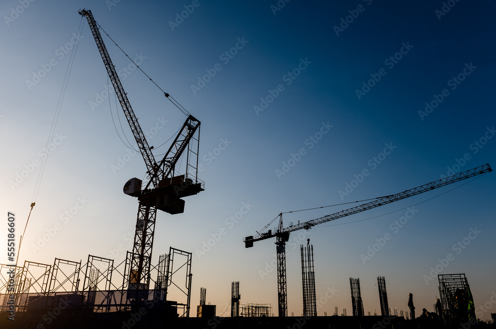 Silhouettes of two cranes against the sky Silhouettes of two cranes against the sky