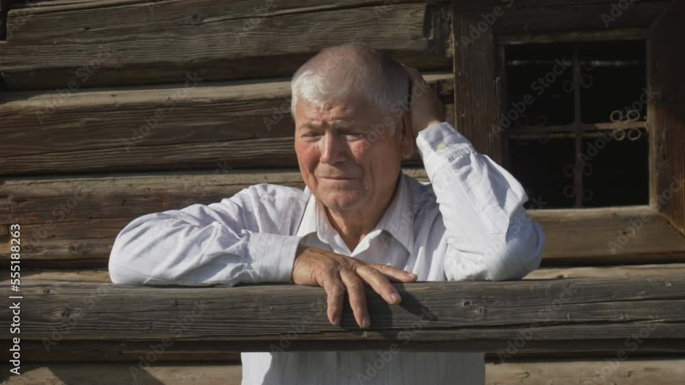 Portrait of thoughtful elderly man on wooden rustic house porch Portrait of thoughtful elderly man on wooden rustic house porch