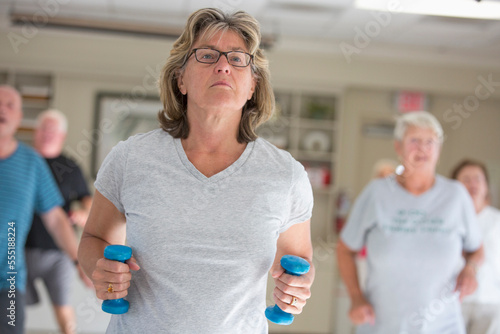 Senior people exercising in gym photo
