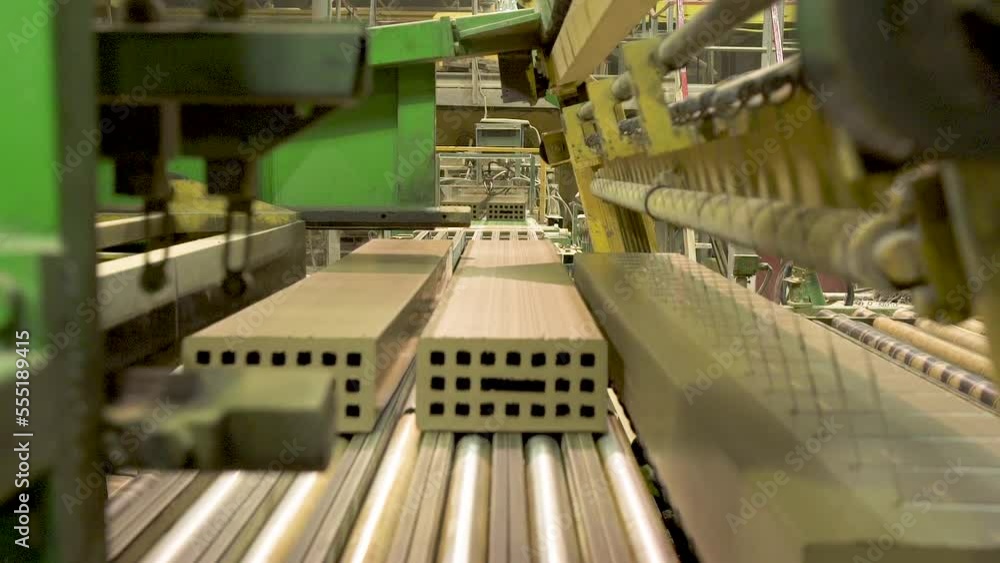 Brick Factory. Production of Bricks and Ceramic Wall Materials for Construction.Modern Factory Machine Carries Bricks from a Working Conveyor.Cutting Clay Billets into Bricks Brick Factory. Production of Bricks and Ceramic Wall Materials for Construction.Modern Factory Machine Carries Bricks from a Working Conveyor.Cutting Clay Billets into Bricks