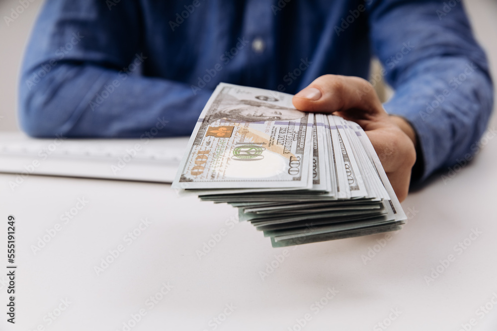Hands of businessman with dollar banknotes. Bribery and corruption concept Hands of businessman with dollar banknotes. Bribery and corruption concept