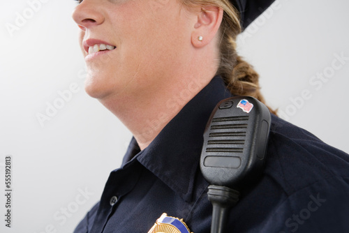 Close up of hand mike on a police woman's shoulder. photo