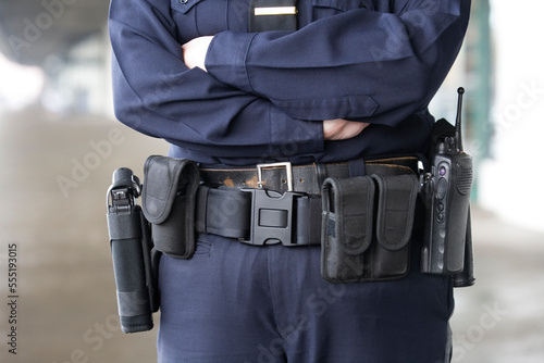 Midsection of a female police officer standing. photo