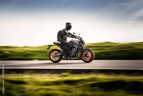 Young guy driving his motorcycle on a mountain road