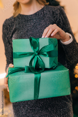 The girl holds in her hands a gift box