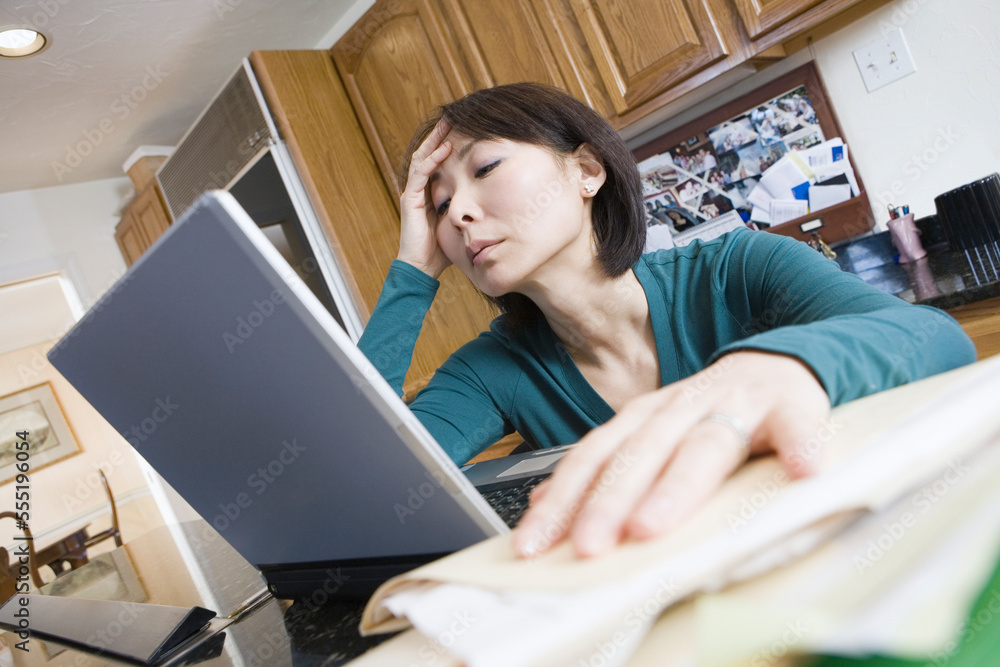 Low angle view of a mid adult woman using a laptop Low angle view of a mid adult woman using a laptop
