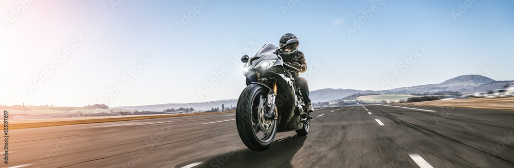 motorbike on the road riding. having fun riding the empty road on a motorcycle tour / journey motorbike on the road riding. having fun riding the empty road on a motorcycle tour / journey
