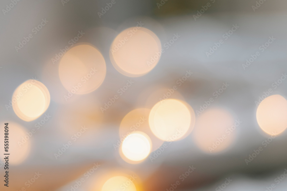 Yellow bokeh effect on a light background. Bokeh background from a garland. Abstract Blurred Christmas Lights Bokeh Background Yellow bokeh effect on a light background. Bokeh background from a garland. Abstract Blurred Christmas Lights Bokeh Background