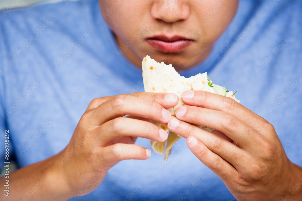 Close up of a man eating a sandwich. Close up of a man eating a sandwich.