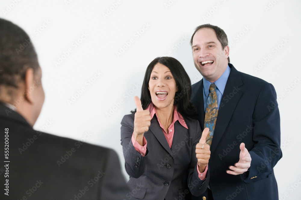Three business executives talking to each other Three business executives talking to each other