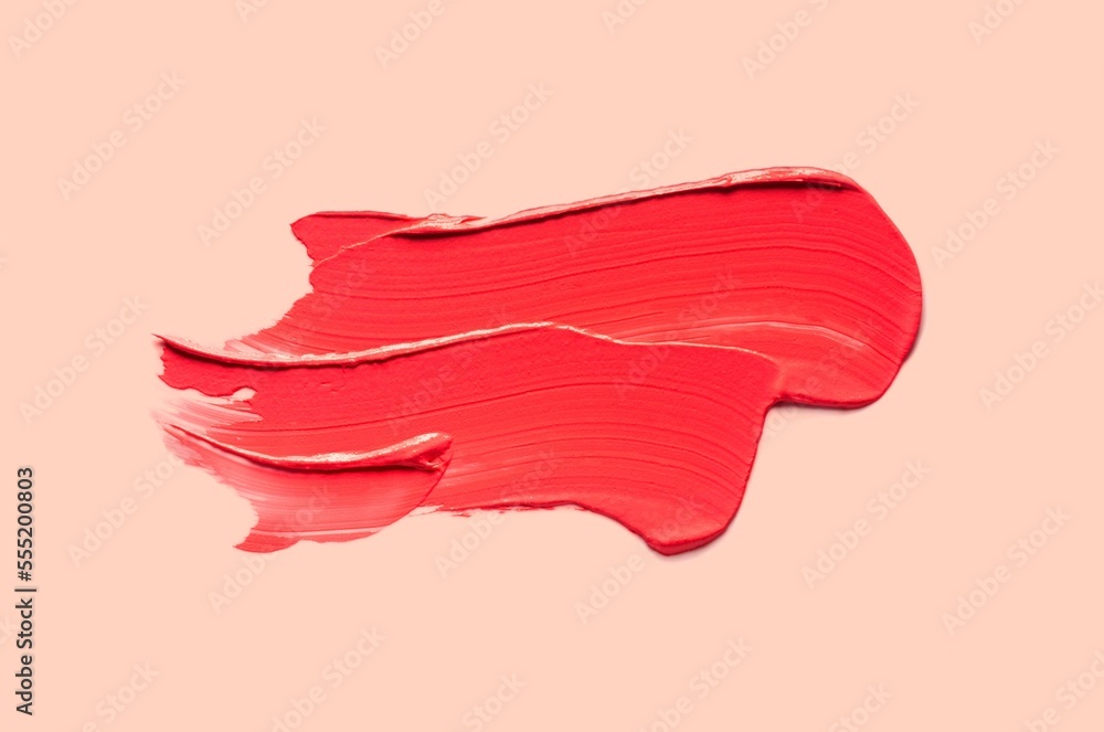 Lipstick or blusher abstract strokes smudges background texture multi colored red blush isolated on coral background Lipstick or blusher abstract strokes smudges background texture multi colored red blush isolated on coral background