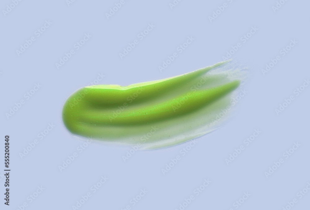 Grassy green lime glossy gel or mask foam cleanser texture isolated on blue Grassy green lime glossy gel or mask foam cleanser texture isolated on blue