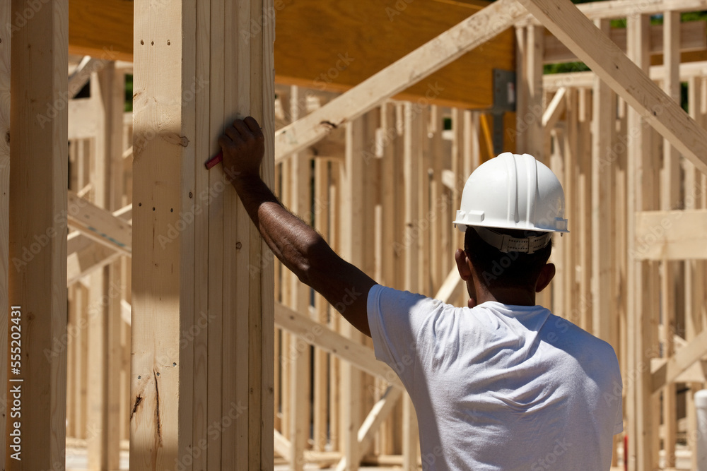 Carpenter standing at a construction site Carpenter standing at a construction site