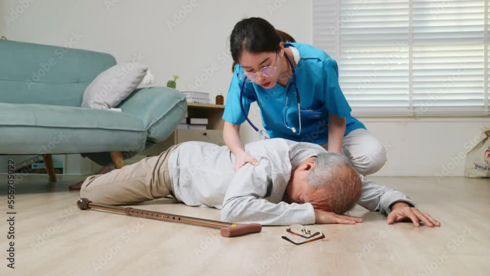 Asian older senior man falling down on lying floor and woman nurse came ...