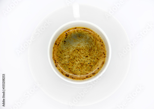 Porcelain coffee cup on a white background. Delicious coffee in a cup and coffee beans.