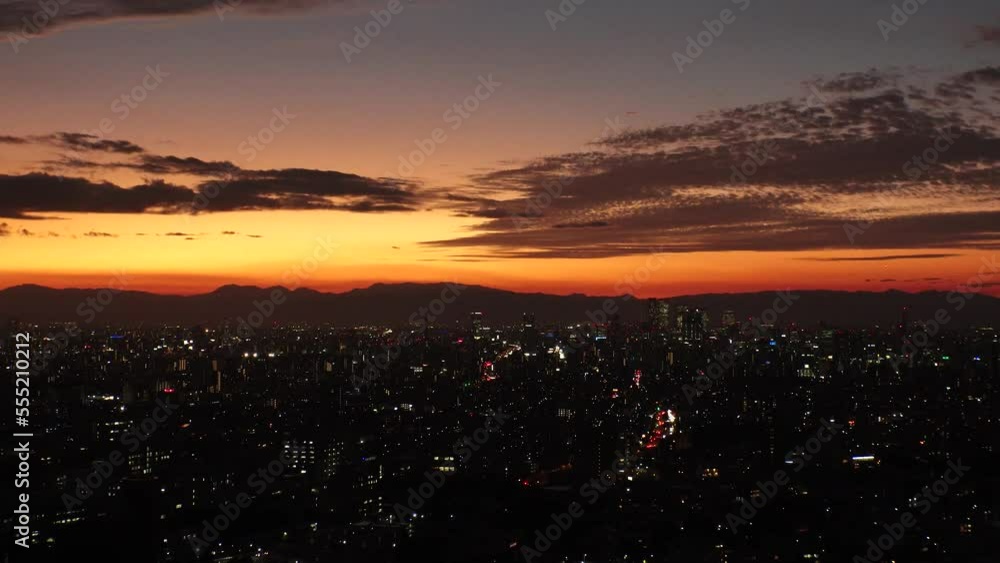 NAGOYA, JAPAN - OCT 2022 : Aerial high angle view of NAGOYA CITY in sunset. View of buildings and street traffic around Nagoya station and Sakae area (central downtown). Time lapse shot, dusk to night NAGOYA, JAPAN - OCT 2022 : Aerial high angle view of NAGOYA CITY in sunset. View of buildings and street traffic around Nagoya station and Sakae area (central downtown). Time lapse shot, dusk to night