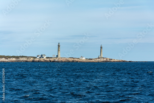 Lighthouse observed from a boat at ocean in a sunny day