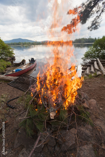 Campfire and canoe at the lakeside, Lake Umbagog, New Hampshire, USA photo