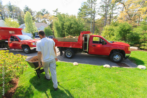 Landscaper moving mulch from a truck photo