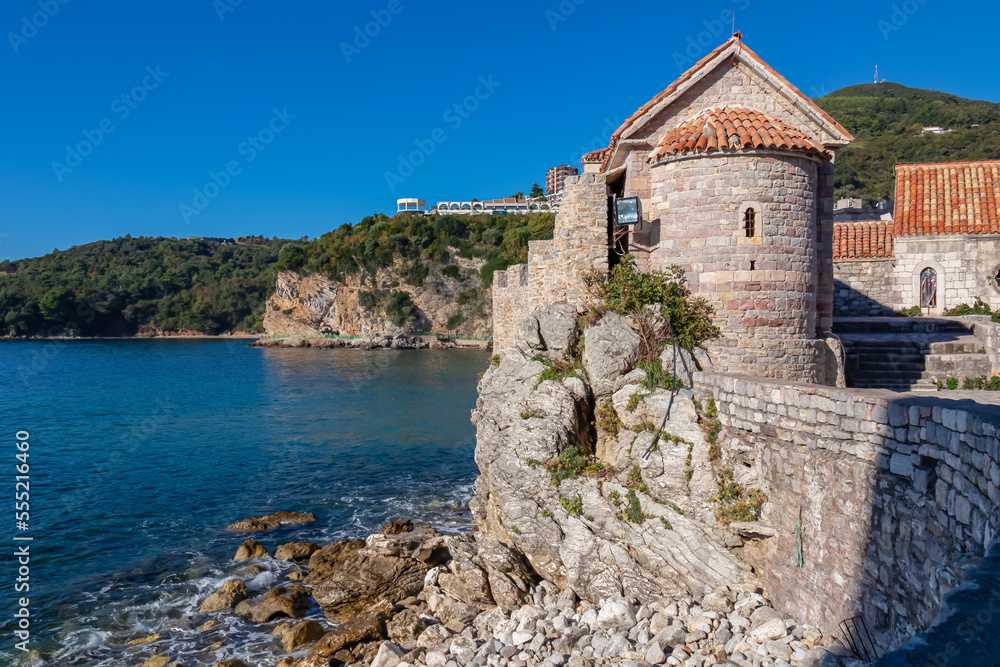 Scenic view of the wall of historical medieval citadel of Budva, Adriatic Mediterranean Sea, Montenegro, Balkan Peninsula, Europe. Old city fortress along the coast. Landmark along Budvanian Riviera