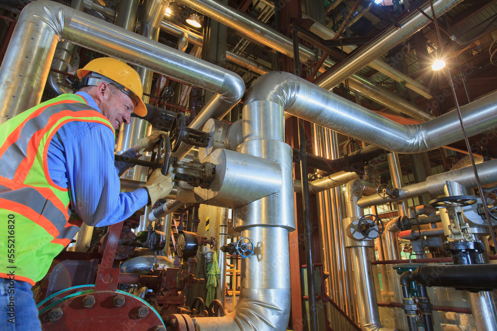 Engineer in electric power plant adjusting condenser piping valve Stock ...
