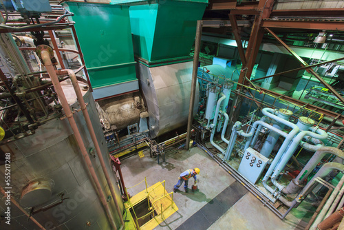 Engineer in gas turbine electric power plant exhaust gas and condensation process room photo