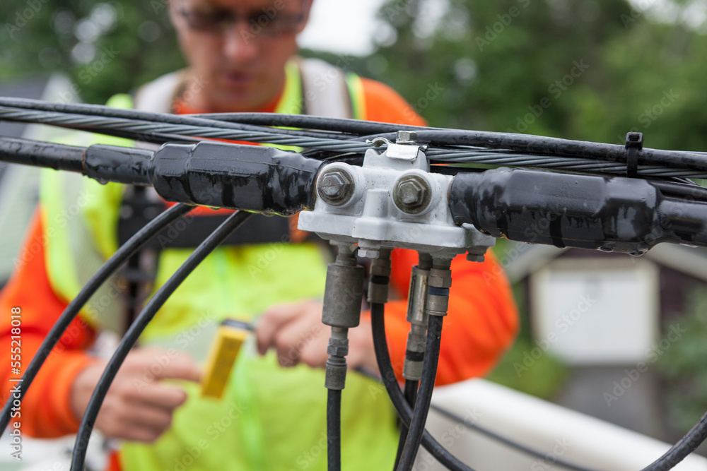 Cable lineman stripping cable for a connection from a bucket truck