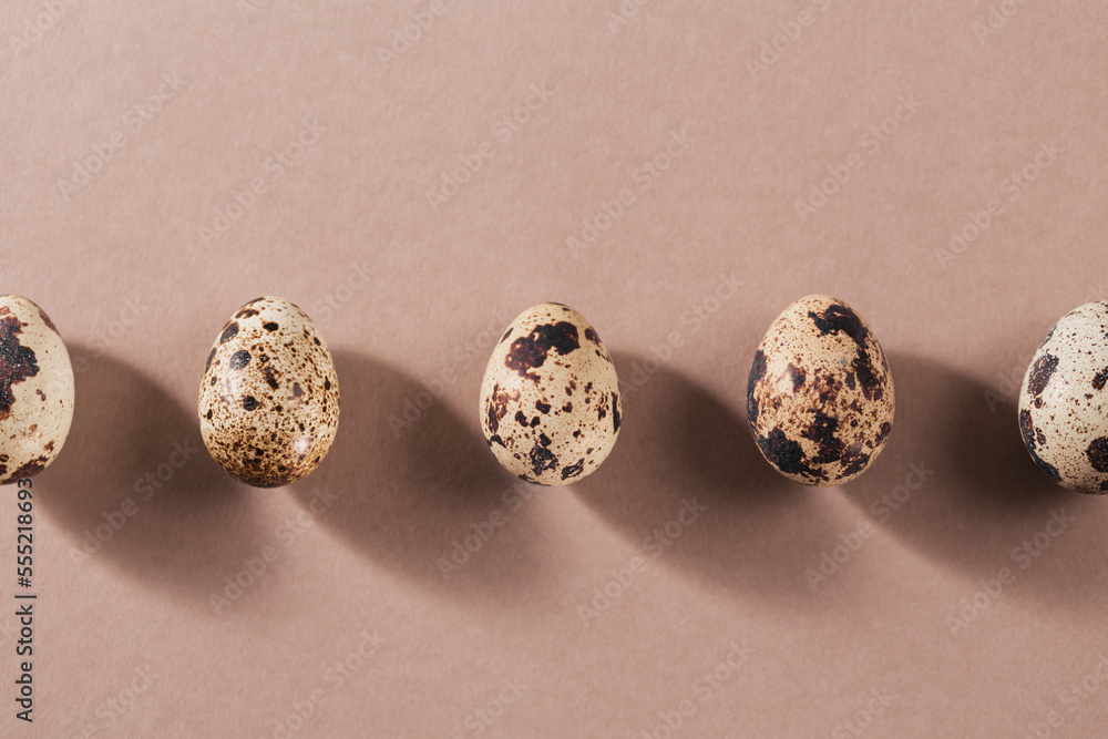 A line with shadows from quail eggs on beige creative minimal background.