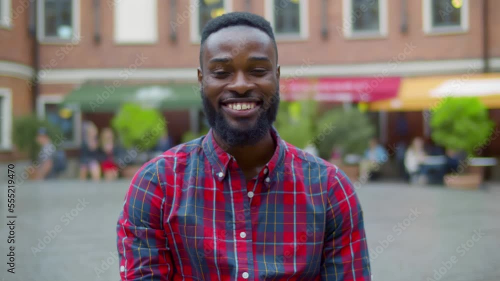 Portrait happy face African-American man looking at camera enjoying in urban city. Realtime Portrait happy face African-American man looking at camera enjoying in urban city. Realtime