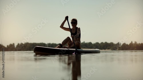  SUP board adventure. Fitness paddleboarding relaxing photo