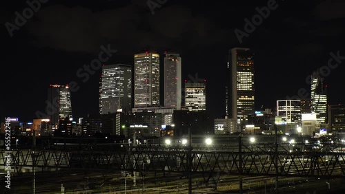 Wallpaper Mural NAGOYA, JAPAN - OCTOBER 2022 : View of buildings around NAGOYA STATION and railroad at night from Koyabashi (bridge). Time lapse shot. Japanese business and transportation concept video. Torontodigital.ca