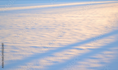 Still expanse of snow at sunset.