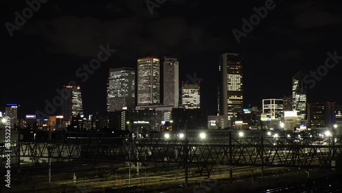 Wallpaper Mural NAGOYA, JAPAN - OCTOBER 2022 : View of buildings around NAGOYA STATION and railroad at night from Koyabashi (bridge). Time lapse shot. Japanese business and transportation concept video. Torontodigital.ca