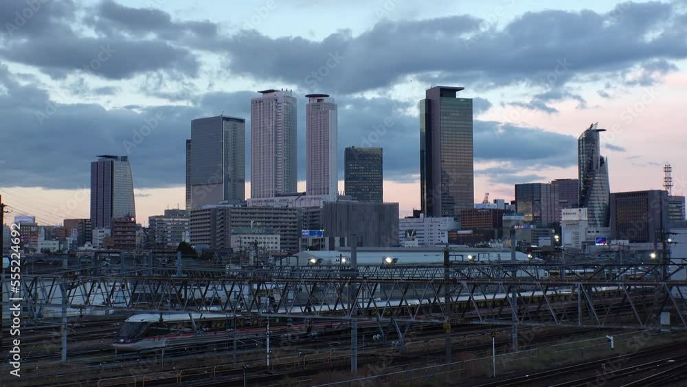 NAGOYA, JAPAN -OCT 2022 : View of office buildings around NAGOYA STATION and railroad in sunset. Time lapse shot, dusk to night. Shot from Koyabashi (bridge). Business and transportation concept video NAGOYA, JAPAN -OCT 2022 : View of office buildings around NAGOYA STATION and railroad in sunset. Time lapse shot, dusk to night. Shot from Koyabashi (bridge). Business and transportation concept video