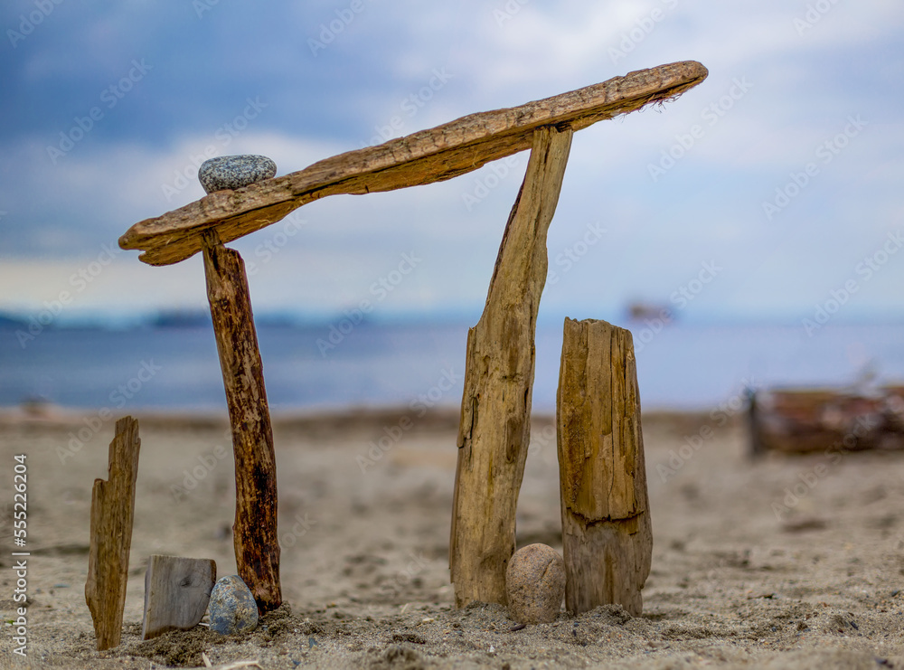 Art structure built in the sand with driftwood and rocks on Ambleside Beach; North Vancouver, British Columbia, Canada Art structure built in the sand with driftwood and rocks on Ambleside Beach; North Vancouver, British Columbia, Canada