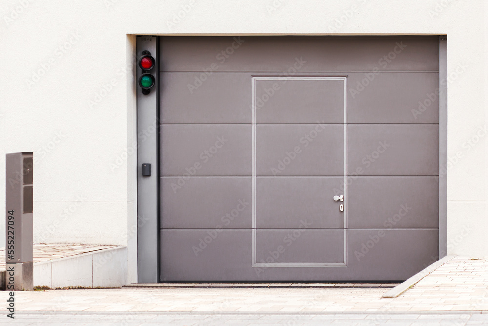 Fototapeta premium Garage Gate or Entrance Door to Underground Private Car Parking of Apartment Building. Modern Garage Gate with Entrance Door, Security System for Car Park