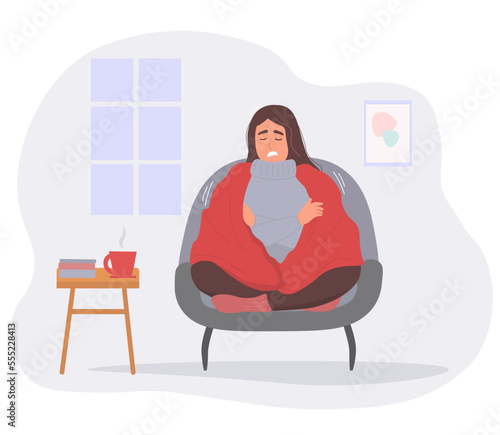 The girl is frozen at home, shivering from the cold under a warm blanket. Vector graphics.