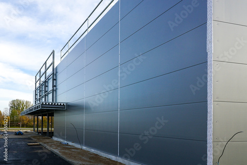 Gray sandwich panel facade of a unfinished warehouse building