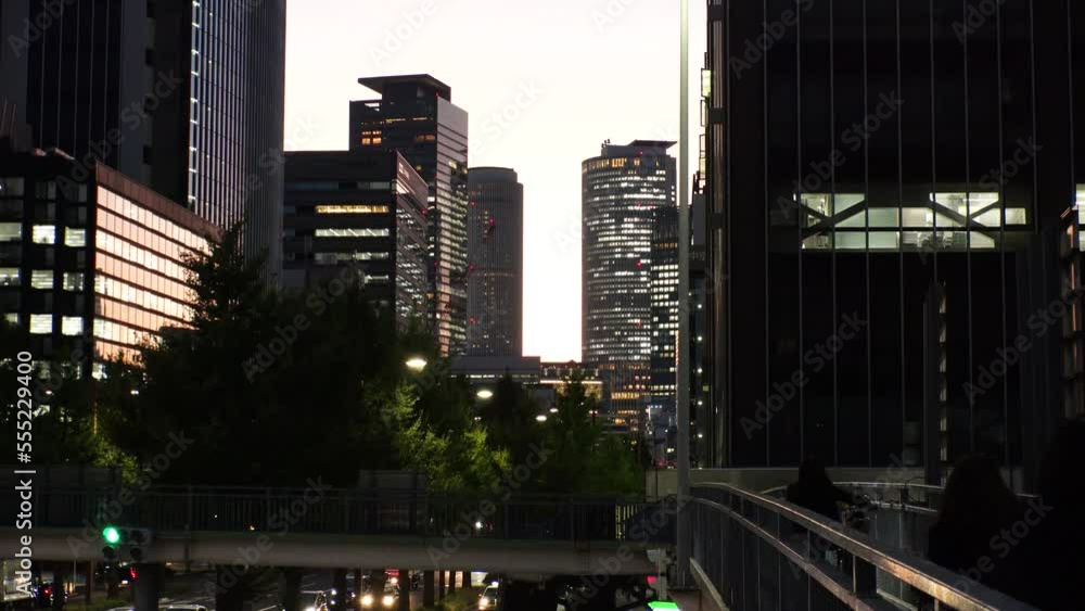MARUNOUCHI, NAGOYA, JAPAN : View of office buildings around NAGOYA STATION and street traffic in sunset. View from the pedestrian bridge. Travel and business concept video. MARUNOUCHI, NAGOYA, JAPAN : View of office buildings around NAGOYA STATION and street traffic in sunset. View from the pedestrian bridge. Travel and business concept video.