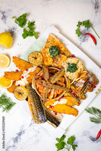 top view of shrimp and fish in assortment on a festive white plate