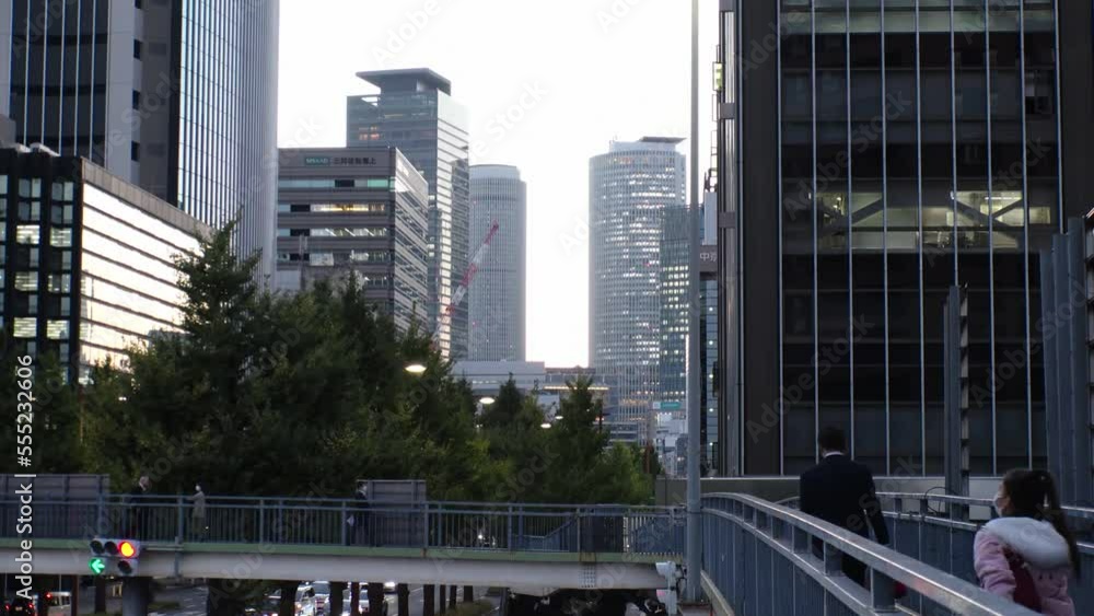 MARUNOUCHI, NAGOYA, JAPAN : View of office buildings around NAGOYA STATION and street traffic in sunset. Time lapse shot, dusk to night. View from the pedestrian bridge. Business concept video. MARUNOUCHI, NAGOYA, JAPAN : View of office buildings around NAGOYA STATION and street traffic in sunset. Time lapse shot, dusk to night. View from the pedestrian bridge. Business concept video.