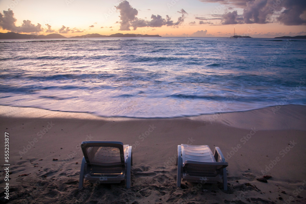 Beach chairs look out to the sunset on a caribbean island; Virgin Gorda, British Virgin Islands Beach chairs look out to the sunset on a caribbean island; Virgin Gorda, British Virgin Islands