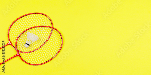 Two badminton rackets and badminton ball shuttlecock isolated on colored background for blog post header or announcement lay top view with copy space. © Anastasiia Ignateva