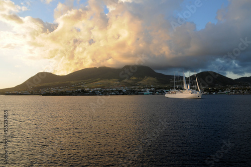 sunset close to St. Kitts caribbean island and cruise ship