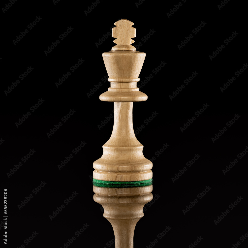 Wooden white chess king isolated at dark background Wooden white chess king isolated at dark background
