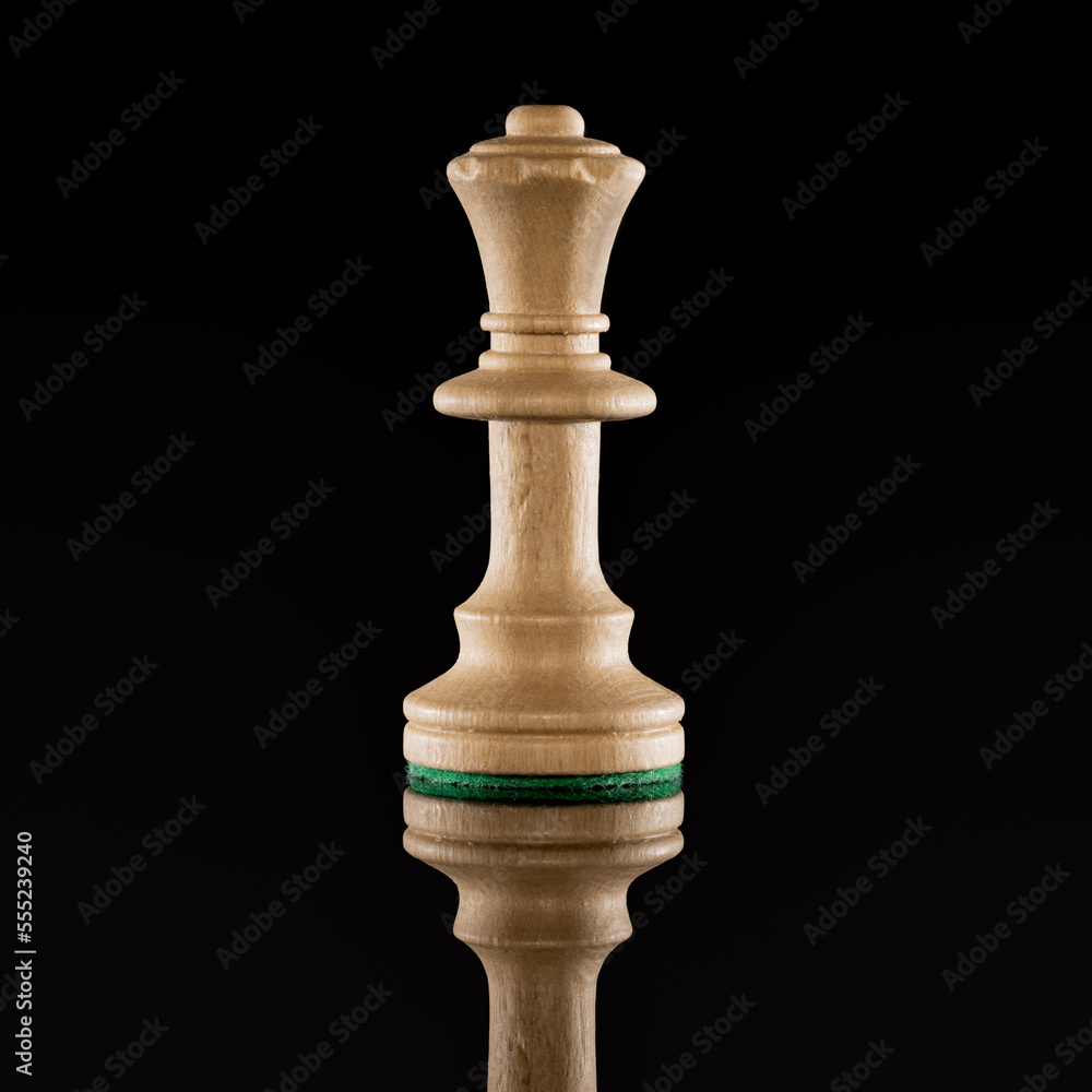 Wooden white chess queen isolated at dark background Wooden white chess queen isolated at dark background