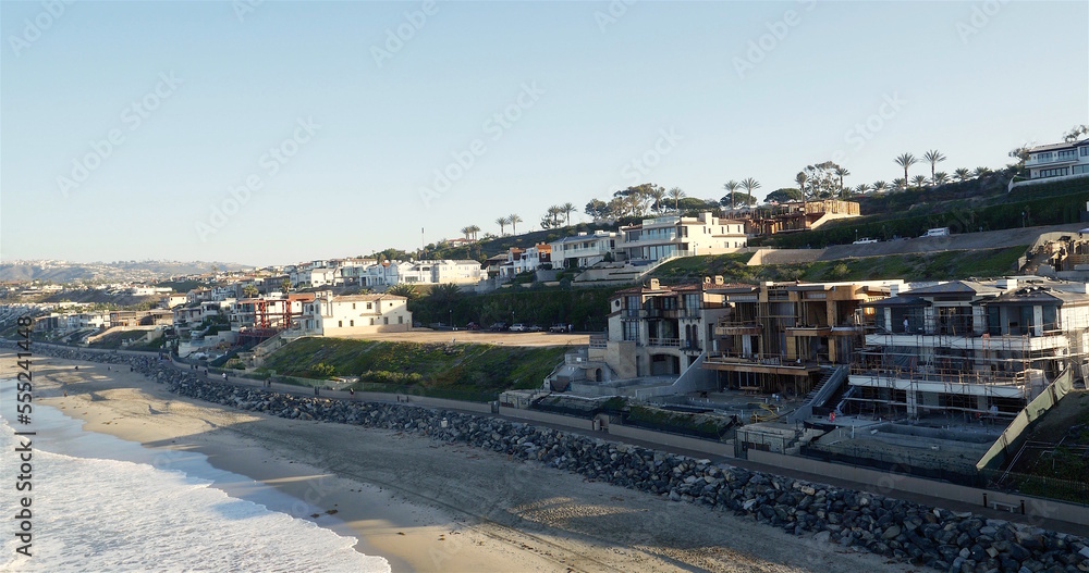 Aerial of Beach front properties in southern California at sunset in Malibu