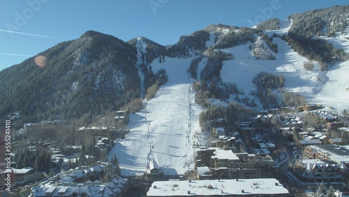 Aerial of Aspen town and ski slope in winter on sunny day