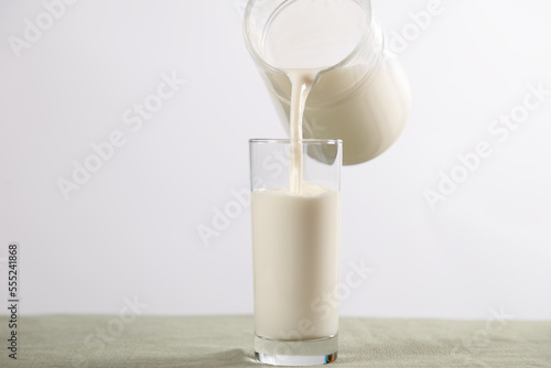white background of jug and glass with milk (ID: 555241868)